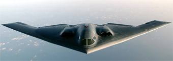 Photo of the B-2 Spirit stealth bomber in flight over an ocean.